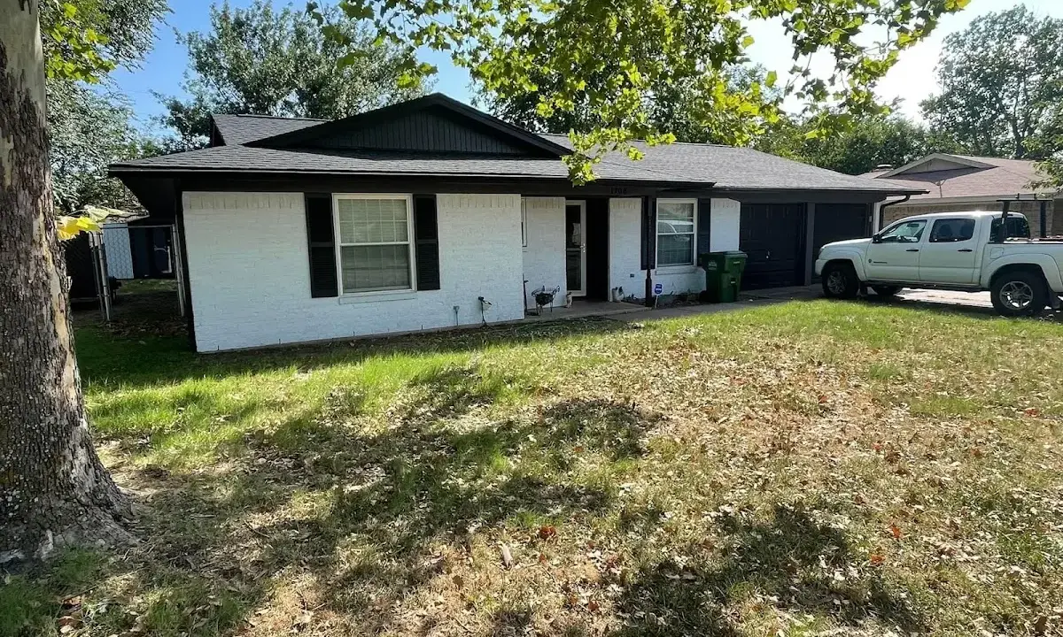 Professional roofing crew working on a residential roof in Windsor